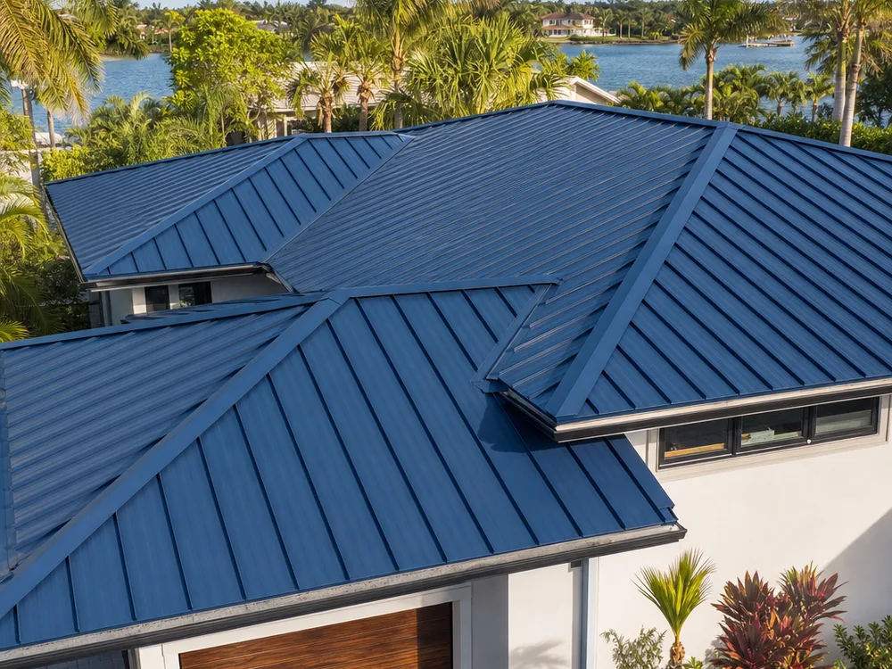 Residential standing seam metal roof with straight panels, clean ridge and hip caps, and crisp edge metal